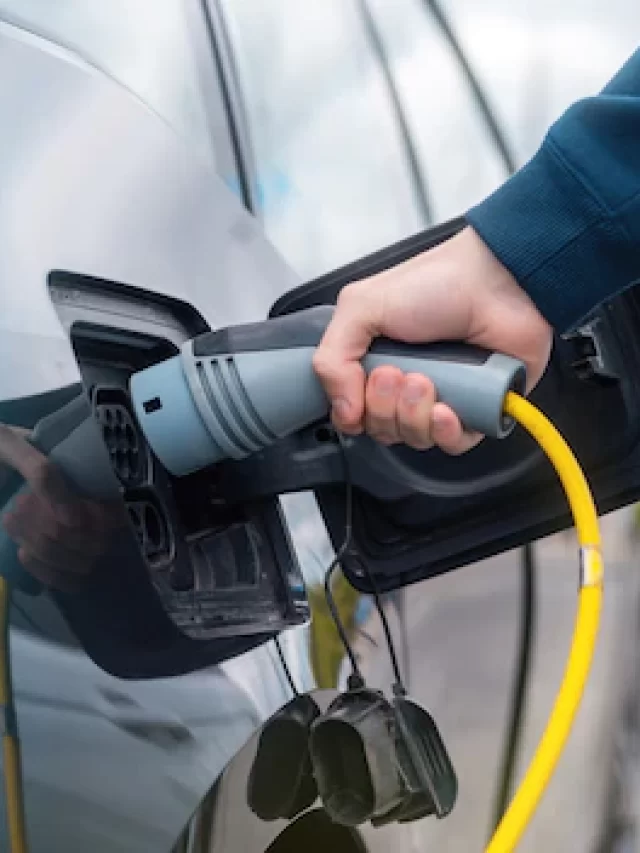 man-plugging-charger-into-electric-car-charge-station_1268-17721